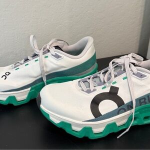 On Running White and Green Athletic Shoes with Cushioned Sole